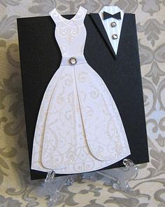 a black and white wedding card with a bride and groom's dress on it