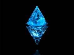 a blue diamond on a black background with reflection in the water and light reflecting off it's side