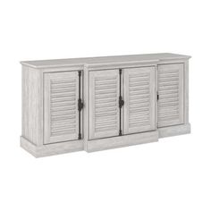 a white cabinet with three doors and shutters on the front, in an angled position