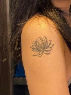 a woman with a flower tattoo on her arm