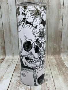 a white and black skull with flowers on it