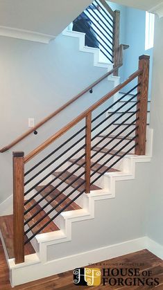 a stair case with wooden handrails in a house