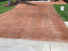 a red brick walkway leading to a house