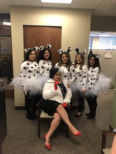 a group of women dressed in costume posing for a photo