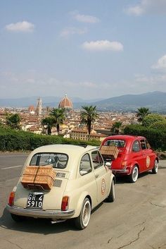 two old cars parked next to each other