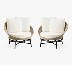 two chairs with white cushions sitting next to each other