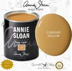 a can of annie sloan wall paint next to an orange and yellow sticker with the words, carnaby yellow on it