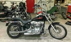 two motorcycles parked in a garage next to each other