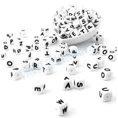 several letters and numbers are scattered around a white bowl filled with dices that spell out words