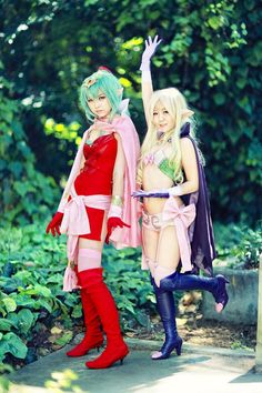 two women dressed in cosplay clothing posing for the camera