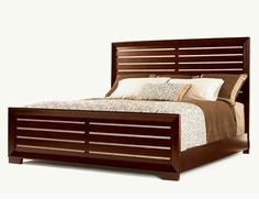 a bed that has some pillows on top of it and is made up with wood slats