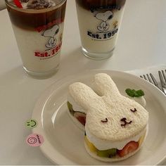 a bunny sandwich on a plate next to a drink