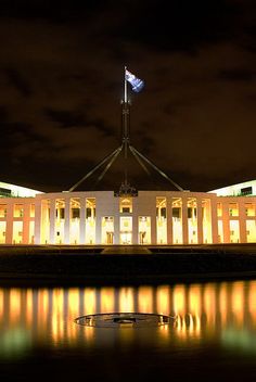 the parliament building is lit up at night