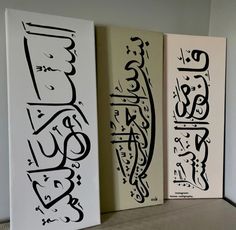 three different types of calligraphy on canvases