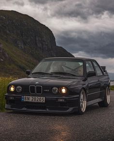 a black car parked on the side of a road