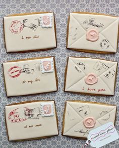 decorated cookies with envelopes and stamps on them