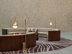 a living room filled with lots of furniture on top of a carpeted floor next to a wall