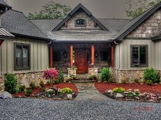 a house that is very nice and has flowers in the front yard on either side