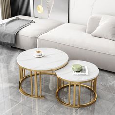 two tables sitting next to each other in front of a white couch and coffee table