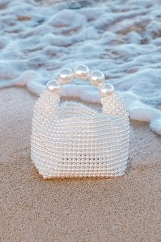 The luxe vibes will be off the charts when you pair your bougiest looks with the Lulus Upgraded Glam White Pearl Handbag! This iconic bag is composed of faux pearl beads that shape a bucket-like body with a flat bottom and a folding top. The interior pocket has plenty of space for all your chicest essentials, and oversized faux pearls form the handle that lends a stunning finish to this statement-making bag. Unlined. 100% ResinWipe With Damp Cloth When Soiled. Imported. Lulus | Upgraded Glam Whi Pearl Handbag, Classic Purse, Lulu Fashion, Cute Handbags, Iconic Bags, Purse Styles, Money Bag, Love Blue, Chic Handbags