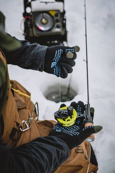 a man holding a fishing pole in the snow