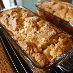 two trays filled with baked goods sitting on top of a stove next to each other