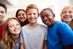 a group of young children standing next to each other