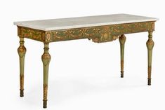 an antique desk with marble top and gold trimmings on the legs, against a white background