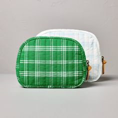 two green and white plaid bags sitting next to each other