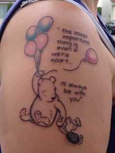 a woman's back with a winnie the pooh tattoo on it