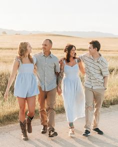 a group of people walking down a dirt road