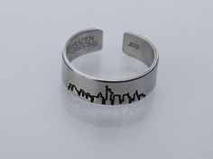 a silver ring with the word san francisco engraved on it's side and an image of a city