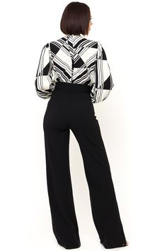 The Black and White Jumpsuit by Bella Chic is the total package, elegant, classic, and stunning! You’ll look completely irresistible in this one piece outfit. Go from career to cocktails in this long sleeve jumpsuit! This black and white jumpsuit starts with a v neck design and a fitted waist top that flows into relaxed wide leg pants, while a waist cinching belt completes this look! This jumpsuit is made of a stretch knit fabric that shapes and hugs your curves. The black and white jumpsuit is Sleek Long Sleeve Pantsuit For Fall, Fall Sleek Long Sleeve Pantsuit, Elegant Long Sleeve Pantsuit For Fall, Elegant Long Sleeve Pantsuit For Workwear, Elegant Long Sleeve Fall Pantsuit, Sleek Long Sleeve Formal Pantsuit, Classic Long Sleeve Evening Pantsuit, Elegant Jumpsuits And Rompers For Evening In Fall, Elegant Evening Jumpsuits And Rompers For Fall