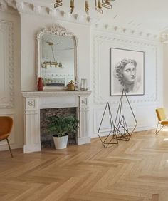 a living room filled with furniture and a fire place next to a painting on the wall