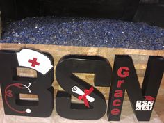 the letters are made out of wood and have nurse's caps on them,