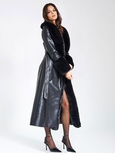 Indulge in opulence with our high quality Zaida Black Faux Fur Trim Vegan Leather Coat. This stunning maxi coat exudes luxury, adorned with puffy fur trim along the neckline and sleeve openings. Crafted from premium vegan leather and soft faux fur, it is fully lined for comfort. The coat features a large snap inside the center waist, along with belt loops and a slender leather belt for effortless closure. Versatile and chic, it adds a touch of sophisticated glamour to any special occasion. Choos Luxury Long Fur Coat, Chic Black Fur Coat With Feather Trim, Long Winter Outerwear For Evening, Long Winter Evening Outerwear, Luxury Long Coat For Evening Wear, Luxury Long Coat For Evening, Elegant Black Full Length Outerwear, Glamorous Faux Fur Outerwear With Faux Fur Lining, Glamorous Faux Fur Lined Outerwear