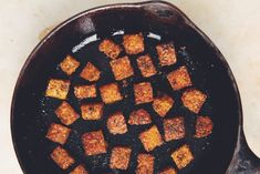 cubed food cooking in a cast iron skillet