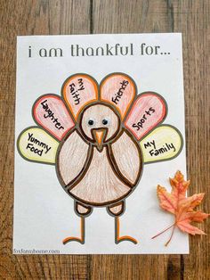 a handmade thanksgiving card with a turkey on it and an orange leaf next to it