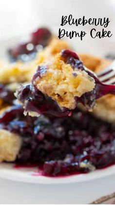 blueberry dump cake on a white plate with a fork in it and text overlay