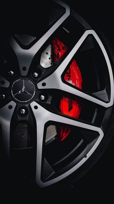 the front wheel of a car with red brake lights