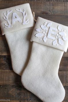 two white christmas stockings with monogrammed letters on them