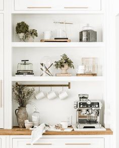 the shelves in this kitchen are filled with coffee and other things to make it look like they have been made out of wood