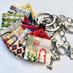 a bunch of different colored fabric keychains on a white surface with metal handles