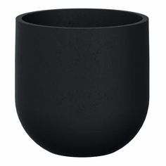 a black cup sitting on top of a white table