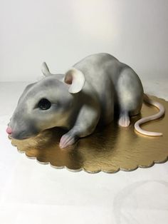 a toy rat sitting on top of a table