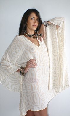 Lovely beige and cream designer tribal print silk Kaftan A perfect soft floaty addition to your summer wardrobe!  I manufactured this unique silk printed cover up for Nuove- Onde. Looks fantastic day or night with your favourite accessories or worn over jeans.  A versatile piece day or night.♥️ Please message me if you have any questions. White Printed V-neck Kaftan, Flowy Beige Kaftan For Summer, Beige Flowy Kaftan For Summer, Summer Beige Flowy Kaftan, Beige Kaftan For Festival Beachwear, Beige Bohemian Kaftan For Summer, Summer Bohemian Beige Kaftan, Bohemian White Cover-up With Boho Print, White Bohemian Cover-up With Boho Print