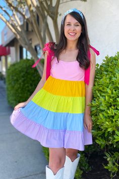 This Multi Color Block Tie Strap Dress is a rainbow of fun! The tiered baby doll design made of cotton poplin will bring out the sunshine in any look. Plus, it comes with adjustable tie straps for a personalized fit. A kaleidoscope of colors awaits! Model is wearing a size small. Stocked at Arlington Village and Uptown. Playful Multicolor Tiered Dress, Playful Multicolor Sundress For Spring, Multicolor Tiered Sundress With Ruffles, Multicolor Sundress With Tie Straps For Spring, Spring Multicolor Sundress With Tie Straps, Rainbow Cotton Dress For Playtime, Playful Rainbow Cotton Dresses, Rainbow Cotton Playtime Dress, Fun Cotton Sundress For Spring