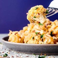 a plate with some food on it and a fork sticking out of the top one