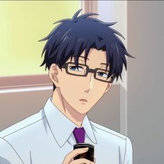 a man with glasses and a tie holding a cell phone in his hand while looking at the screen