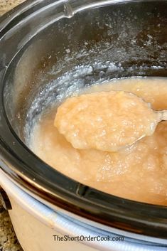 a spoon is stirring some food in the slow cooker